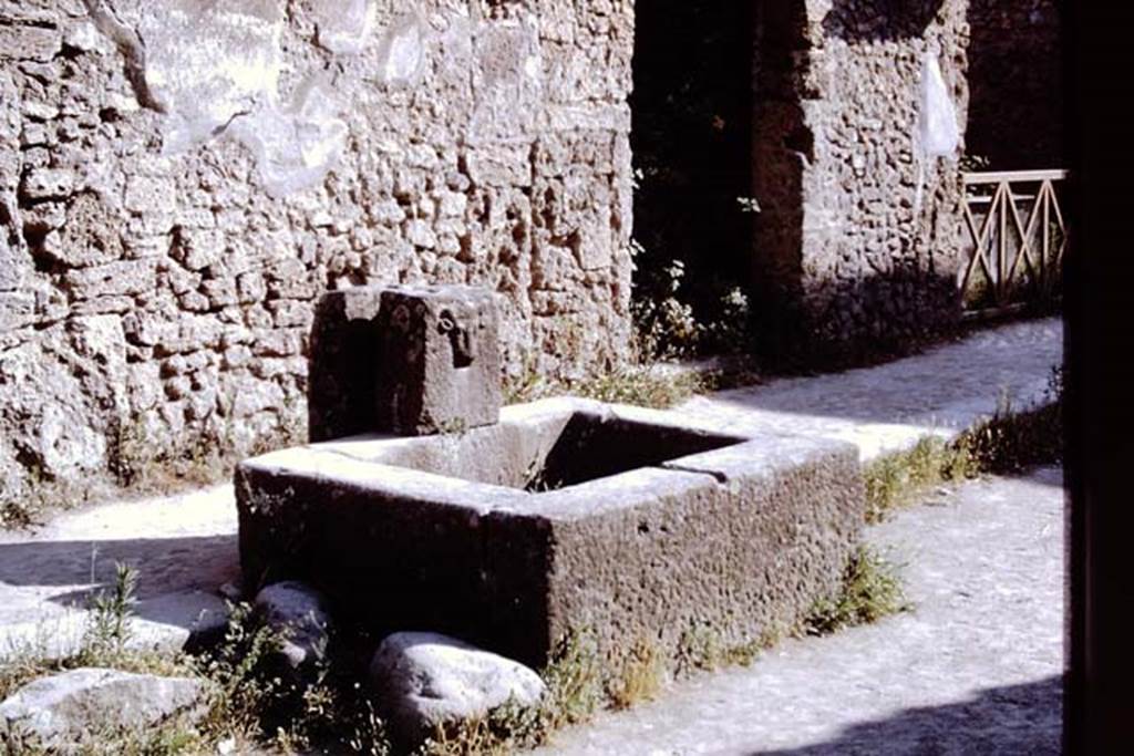 Fountain on Via dell Abbondanza between II.1.2 and II.1.3. Pompeii, 1968. 
Photo by Stanley A. Jashemski.
Source: The Wilhelmina and Stanley A. Jashemski archive in the University of Maryland Library, Special Collections (See collection page) and made available under the Creative Commons Attribution-Non Commercial License v.4. See Licence and use details.
J68f0305
