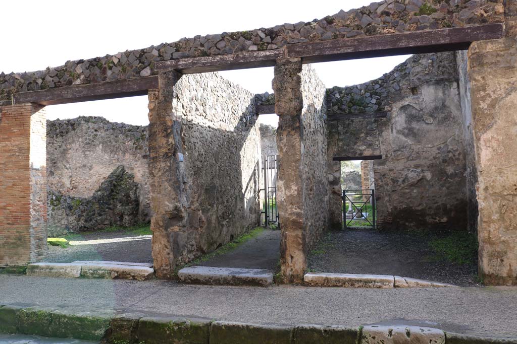 I.8.6, on left, I.8.5, centre, and I.8.4, on right, Pompeii. December 2018. 
Looking south to entrances on Via dellAbbondanza. Photo courtesy of Aude Durand.
