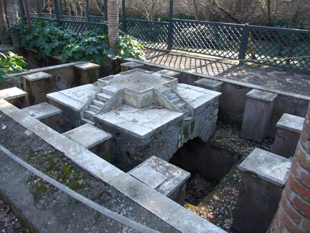 II.2.2 Pompeii. March 2009. Room “l”, garden. Pool and fountain shaded by pergola. 
Looking south-west from north end. The fountain has four sets of marble steps on a central platform. 
Around the edge are twelve statue or fountain ornament bases.
