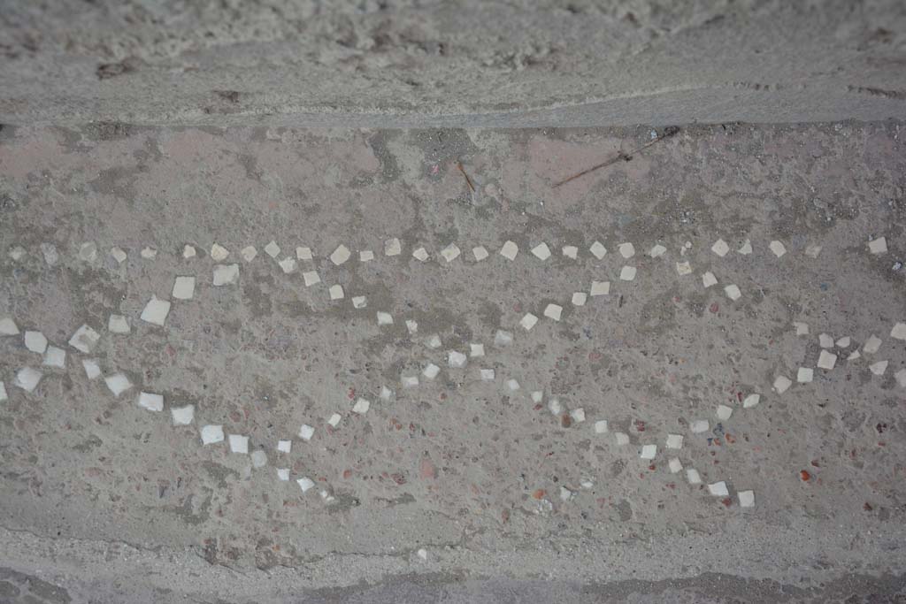 II.2.2 Pompeii. July 2017. Entrance corridor/fauces 1, detail of remains of pattern showing net design in small white stones. 
Foto Annette Haug, ERC Grant 681269 DCOR.

