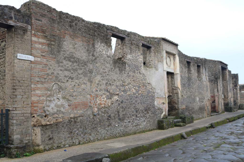 II.2.4 Pompeii. December 2018. 
Looking west on south side of Via dellAbbondanza towards II.2.4 through to II.2.1. Photo courtesy of Aude Durand. 

