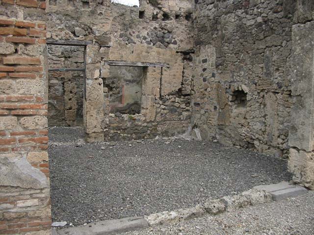 IX.6.e Pompeii. May 2005. Looking north across shop entrance. On the left, west wall, would have been the steps to the upper floor. In the north wall is a doorway into room c of IX.6.d, and a window into room d (see IX.6.d) According to Mau, this was described as number 10, of IX.6. 
See BdI, 1881, (p.25)
See Eschebach, L., 1993. Gebudeverzeichnis und Stadtplan der antiken Stadt Pompeji. Kln: Bhlau. (p.428)

