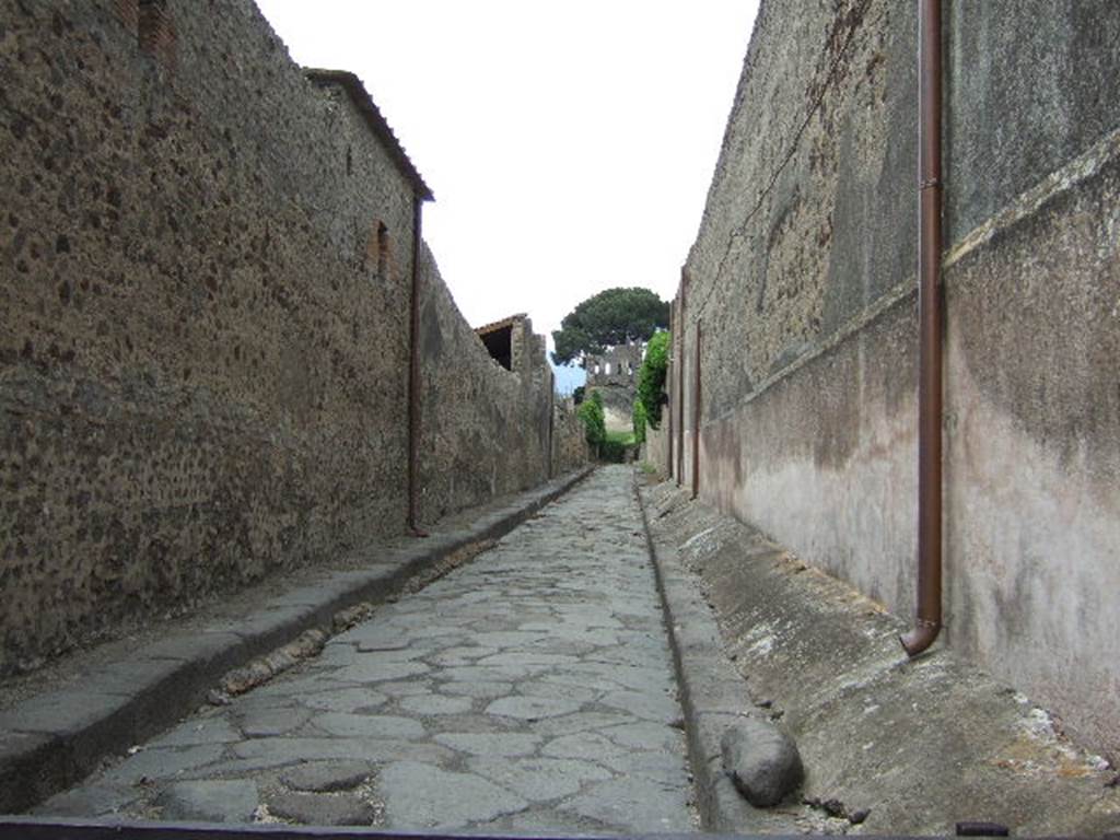 Vicolo del Labirinto, Pompeii. May 2006. Looking north along east wall of VI.11.10, on left, with VI.15, on right.