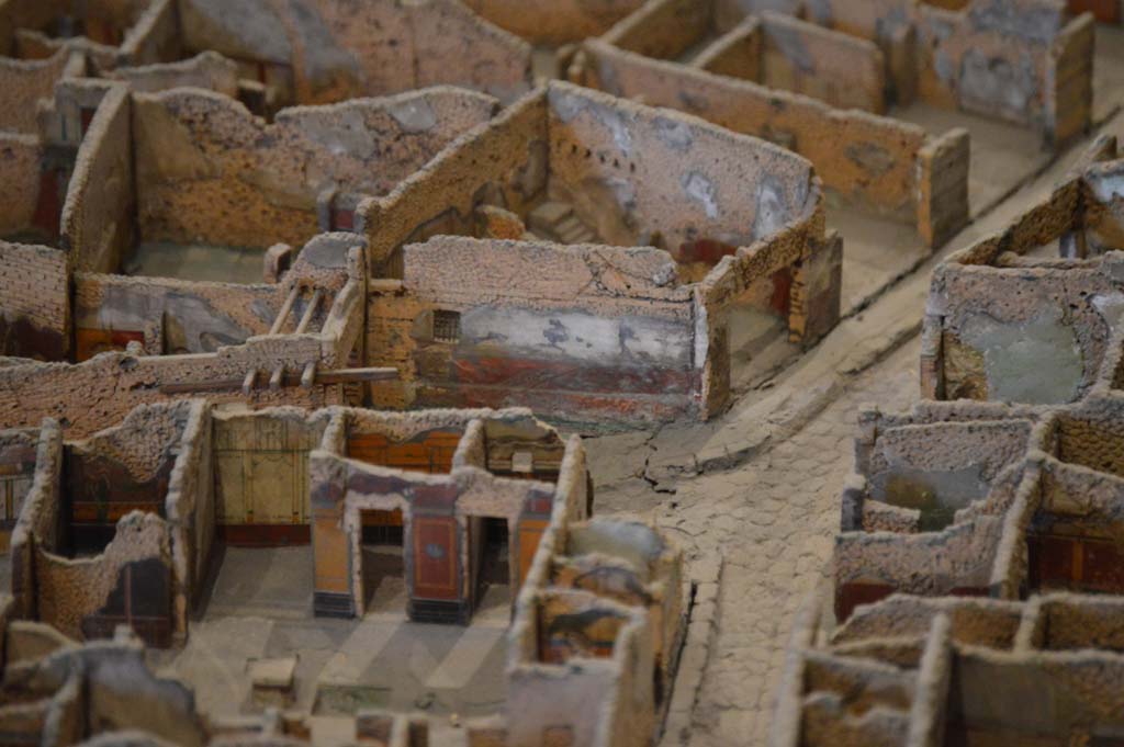 Vicolo del Lupanare, Pompeii. March 2019. Detail from model in Naples Archaeological Museum.
Looking west between VII.1.and VII.12, from above VII.1.40, towards painted decoration on wall of VII.12.14, in centre.
Foto Taylor Lauritsen, ERC Grant 681269 DÉCOR
