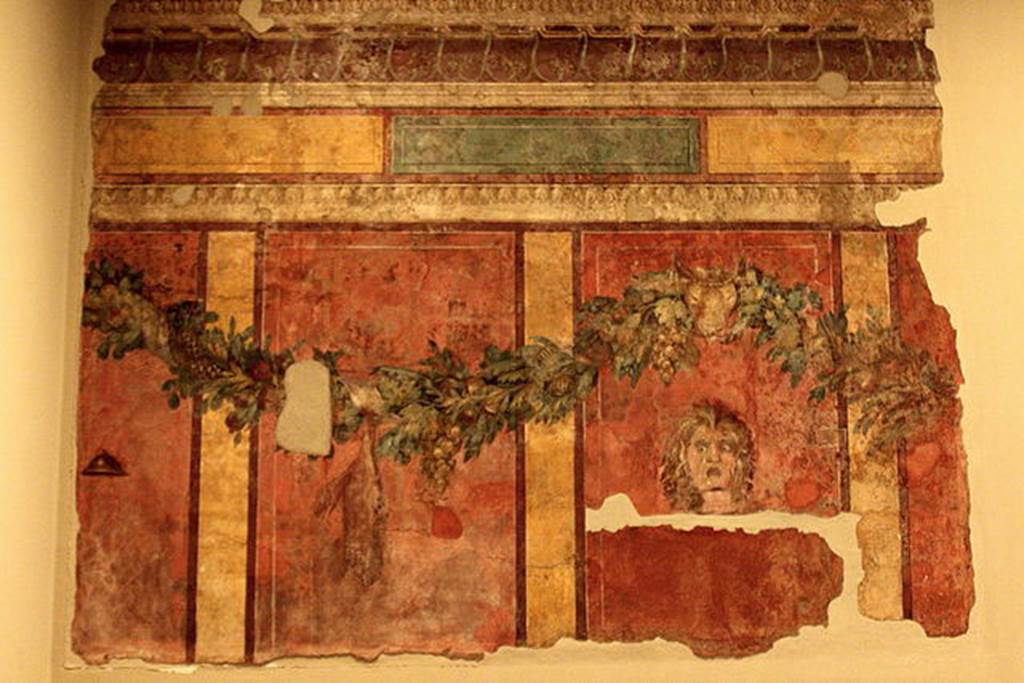 Villa of P. Fannius Synistor at Boscoreale. Room L, tablinum, rear wall. 
Garlands are supported by a ceremonial bulls head.
A satyr mask is in right hand panel which would have been the centre of the wall.
In the panel to the left of the mask a dead hare is suspended from the garland.
In the panel to the far left is a small cymbal (cymbalum).
Photo courtesy of Michel Wal, Wikimedia Commons. 
This photo is subject to an Attribution-ShareAlike 3.0 Unported licence.
Now in the Muse Royal de Mariemont, Morlanwelz, Belgium. Inventory number R61.
http://www.musee-mariemont.be/
