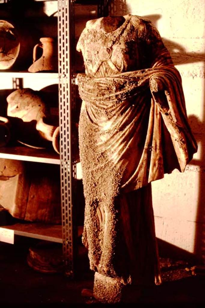 Oplontis Villa of Poppea, 1983-1984. Beautiful marble statue of headless Nike, in the deposits for safekeeping.
Source: The Wilhelmina and Stanley A. Jashemski archive in the University of Maryland Library, Special Collections (See collection page) and made available under the Creative Commons Attribution-Non Commercial License v.4. See Licence and use details.
Oplo0189
SAP Inventory number 73302.
