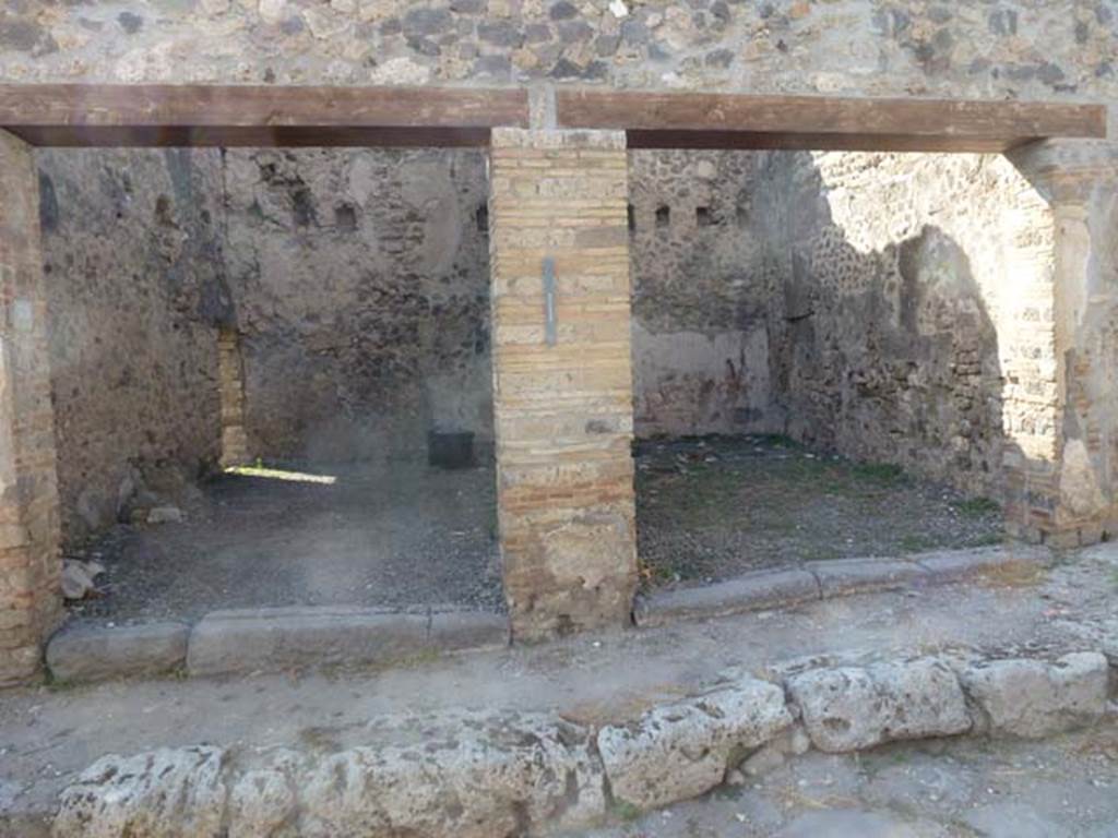 VII.6.35 Pompeii, on left. June 2012. Looking north towards entrances of VII.6.35 and VII.6.34.
On the pilaster between VII.6.35 and 34 (in the centre) would have been a painting of Victory, a donkey and a lion, now in Naples Archaeological Museum. (see VII.6.35)
According to Garcia y Garcia, on the pilaster between VII.6.36 and 35 (on the left, corner pilaster) would have been a painting of Mercury, now destroyed.
See Garcia y Garcia, L., 2006. Danni di guerra a Pompei. Rome: L’Erma di Bretschneider. (p.109) 

According to Della Corte, on the pilaster between VII.6.36 and 35 (on the left) there was a painting of Bacchus, now destroyed.
He agreed that the Victory, donkey and lion, were shown on the middle pilaster.
Many graffiti were found written under these paintings, including amongst others, the names of boys and girls who possibly worked here [CIL IV 1627-1649].
See Della Corte, M., 1965.  Case ed Abitanti di Pompei. Napoli: Fausto Fiorentino. (p.169-171)

According to Frohlich, on the left corner pilaster, would have been Mercury.
He agreed that the Victory, donkey and lion, were shown on the middle pilaster.
See Fröhlich, T., 1991. Lararien und Fassadenbilder in den Vesuvstädten. Mainz: von Zabern. (p.327, F51)

According to Fiorelli, on the extreme pilaster, was the figure of Bacchus, with Mercury on the other.
Under the figure of Mercury were many inscriptions, two of the most important being –

Si quis forte meam cupiet viol(are)
puellam illum in desertis
montibus urat amor    [CIL IV 1645]

Alliget hic auras (Della Cortes thought «  aures ») si quis obiurgat amantes
Et vetet assiduas currere fontis aquas    [CIL IV 1649]

See Pappalardo, U., 2001. La Descrizione di Pompei per Giuseppe Fiorelli (1875). Napoli: Massa Editore. (p.160)

According to Boyce, on the two outer pilasters bordering the entrances of these two shops, the figures of Mercury and Bacchus.
See Boyce G. K., 1937. Corpus of the Lararia of Pompeii. Rome: MAAR 14. (p.111, no.17).
