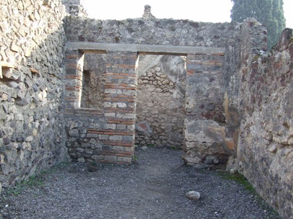 VIII.4.10 Pompeii. December 2007. Looking south to rear room.
According to Boyce –
In the south wall of the main room, a window was walled up, and a niche thus formed, to serve, according to Fiorelli, as a lararium. 
Fiorelli, Giorn. Scavi, 1861, 105; Scavi, 4; Descr., 339.
See Boyce G. K., 1937. Corpus of the Lararia of Pompeii. Rome: MAAR 14.  (p.76)
See Pappalardo, U., 2001. La Descrizione di Pompei per Giuseppe Fiorelli (1875). Napoli: Massa Editore. (p.128)

