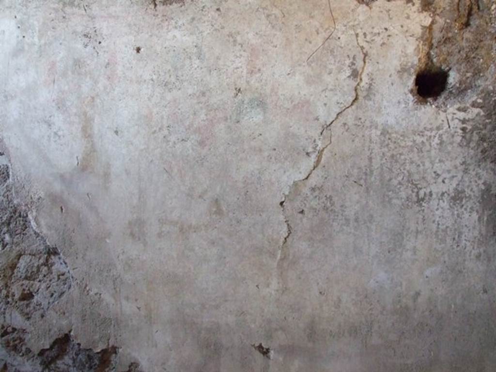 I.12.9 Pompeii. December 2007. East wall of kitchen. According to PPP and Giacobello, on the east wall of the kitchen above the bench was a lararium, now completely disappeared. According to PPP, the Lararium was shown with altar, offerings, a Lar, and a decayed serpent.
According to Giacobello, in the upper part was the figure of the Genius sacrificing near an altar. He was assisted by two people, presumably the camillo and the tibicine. On his left, was a painted Lar with his arm held high, near to him was a large ham. Upon discovery, the serpent near an altar in the lower zone was only partially conserved.  See Giacobello, F., 2008. Larari Pompeiani: Iconografia e culto dei Lari in ambito domestico.  Milano: LED Edizioni. (p.153)   See Bragantini, de Vos, Badoni, 1981. Pitture e Pavimenti di Pompei, Parte 1. Rome: ICCD. (p.176)
