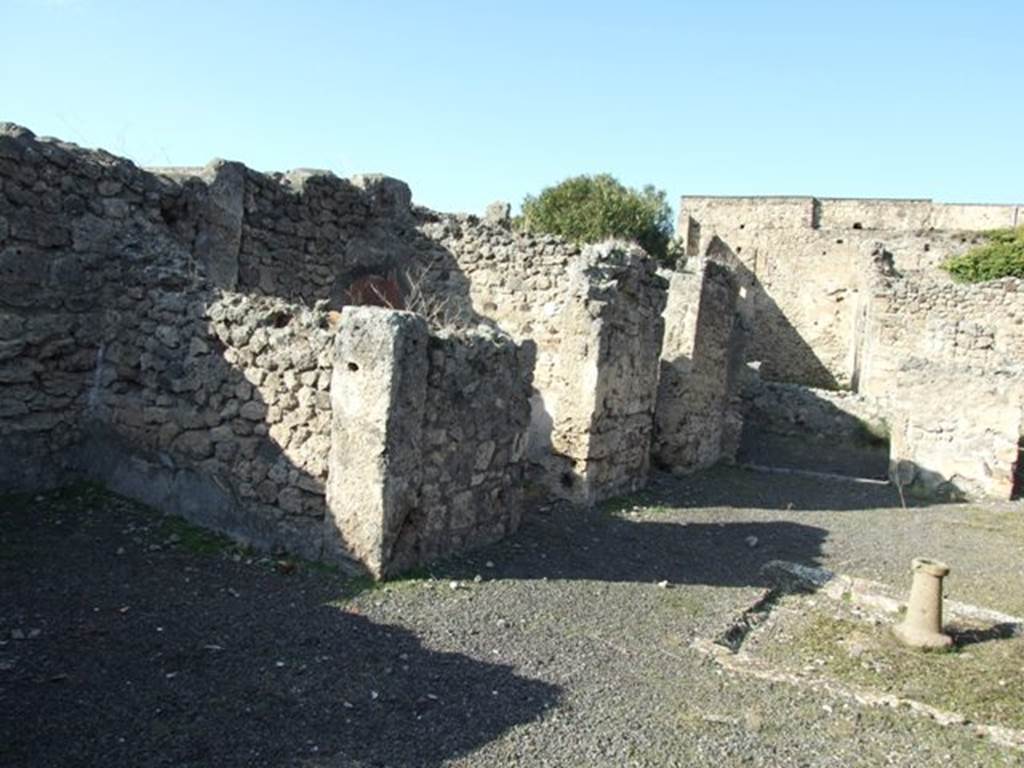 V.2.7 Pompeii. December 2007. Rooms 2, 3 and 4 on west side of atrium and room 5, tablinum/triclinium on north side.
According to Boyce, in the west wall of the atrium between the doorways to rooms 3 and 4, was a niche.
Its inside walls were coated with white stucco which was adorned with little red and black spots.
Boyce said, according to Mau it was la nicchia del larario.
See Boyce G. K., 1937. Corpus of the Lararia of Pompeii. Rome: MAAR 14. (p.34, no.89) 

