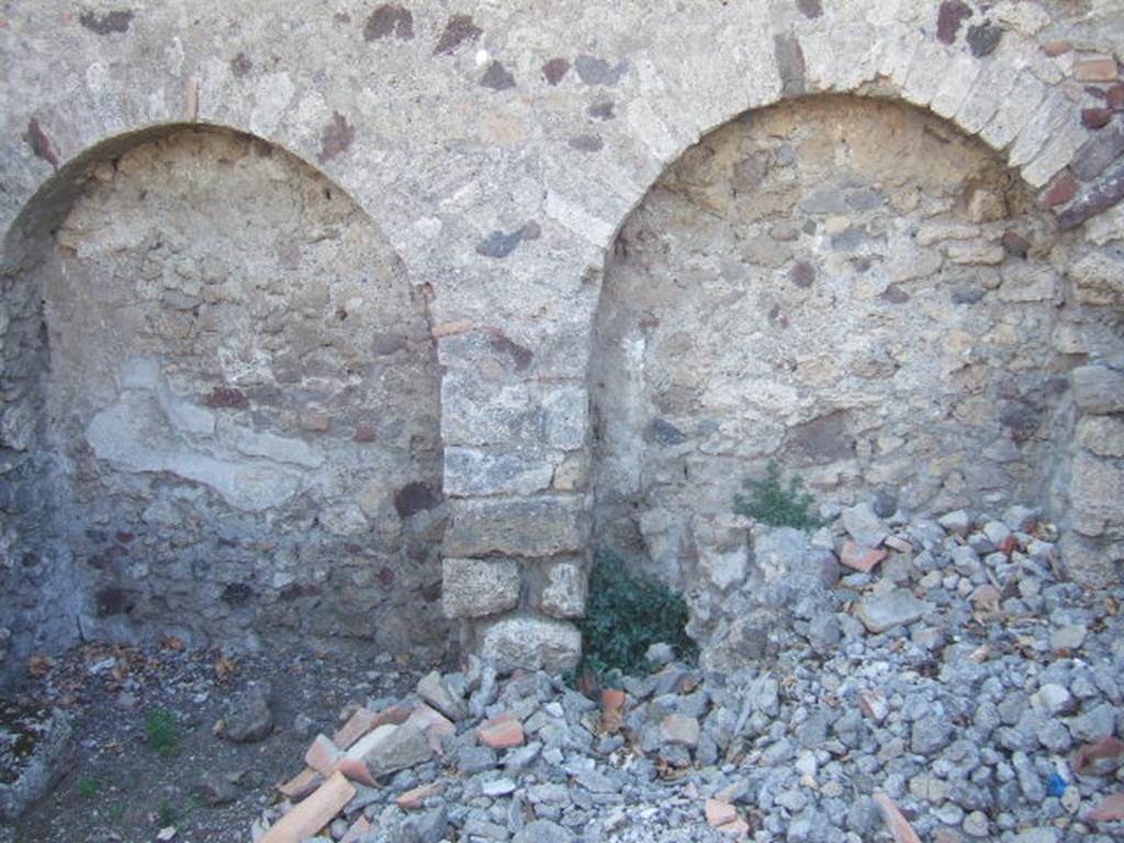 VI.9.2 Pompeii. September 2004. Room 38, west wall of kitchen. The lararium painting was found in an area marked “u” on a plan by Overbeck. This would coincide with the arched area on the right.
