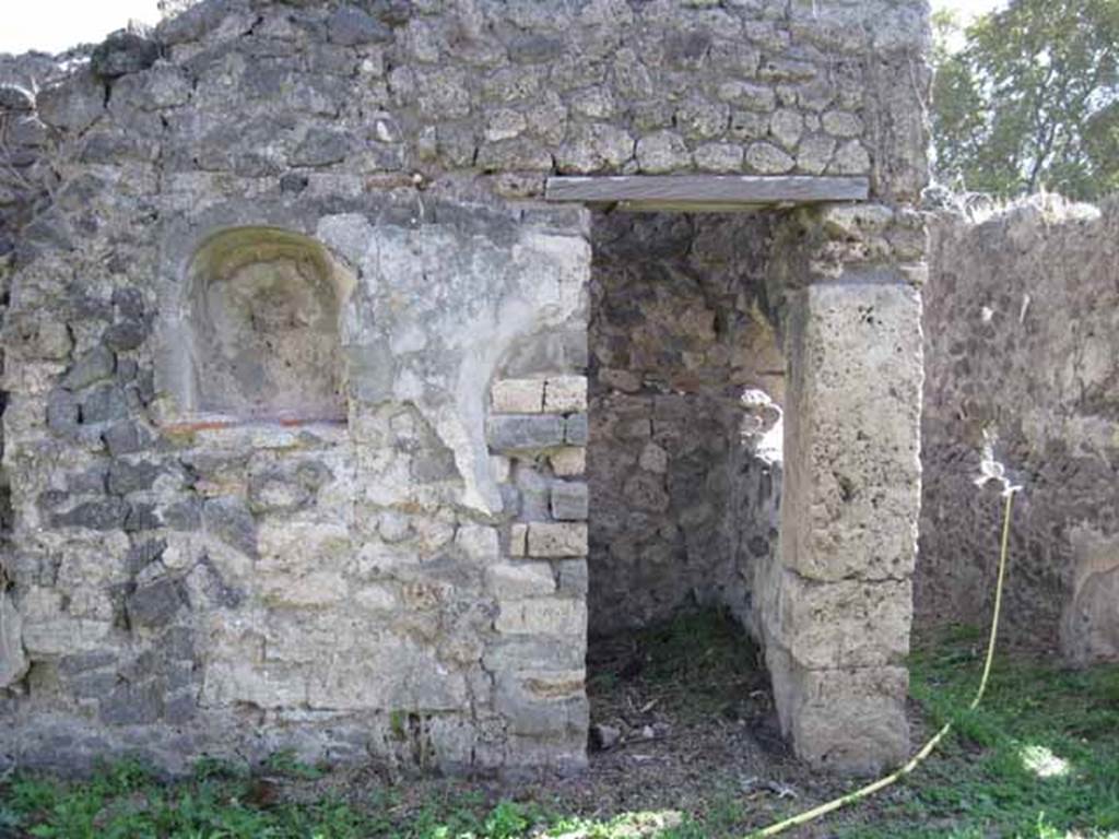 I.2.24 Pompeii. September 2010. West half of south wall of atrium, with niche and small doorway to room (cupboard or repository) that would have been under the stairs. Photo courtesy of Drew Baker.
