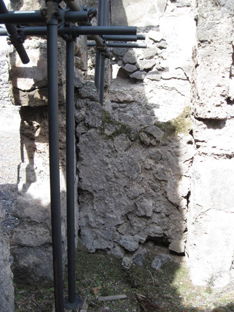 I.3.3 Pompeii. September 2010. North wall of second triclinium, with detail of blocked doorway in north-west corner. According to Mau, this blocked doorway led through to the stairway that lead up to the peristyle.  See Mau, A: BdI 1874, (p.178-9). Photo courtesy of Drew Baker.
