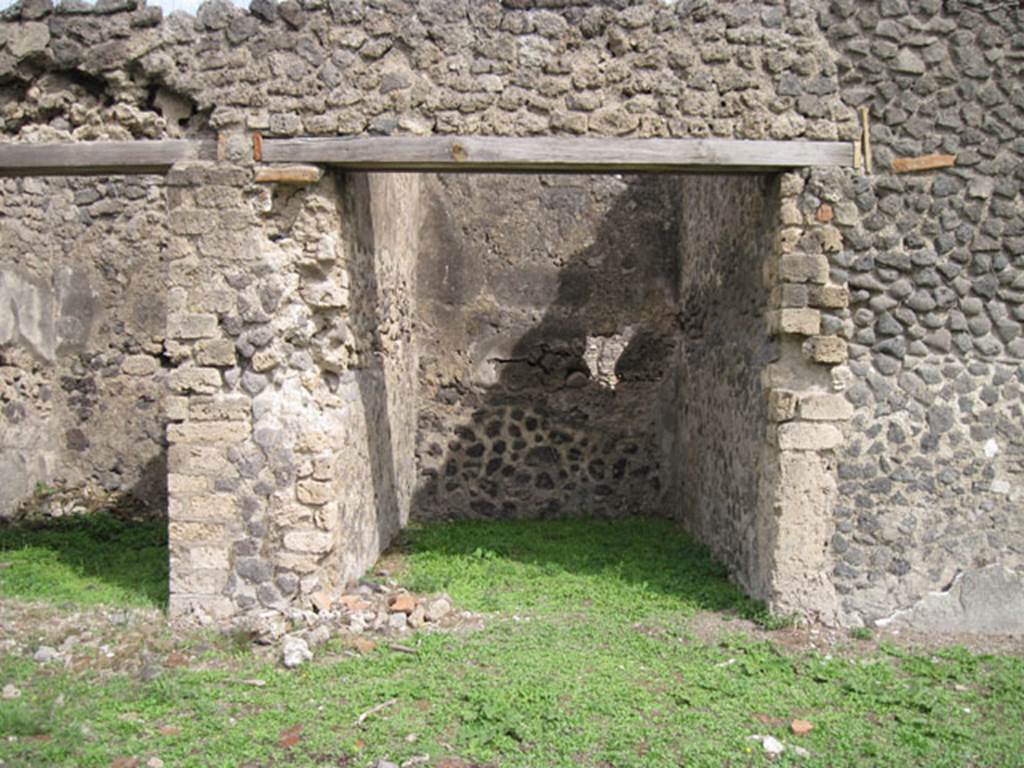 I.3.3 Pompeii. September 2010. Upper peristyle area, looking east to doorway to a small room which, according to Fiorelli and CTP, contained another staircase to access this side. 
The staircase was to be found against the north wall of the room (on the left) near the pile of stones on the floor. Photo courtesy of Drew Baker.
