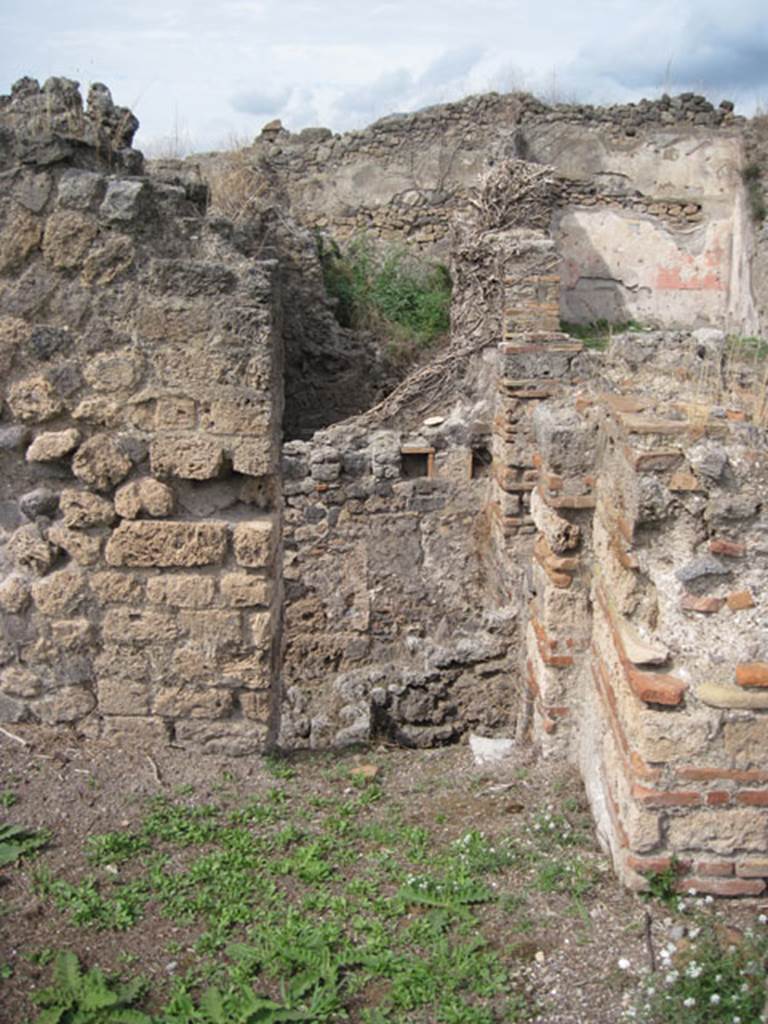 I.3.3 Pompeii. September 2010. Upper peristyle area, looking north in north-east corner of exedra or triclinium, through doorway leading into void over lower room. Note putlog holes on other side however. The doorway originally led into the sloping corridor, over the corridor on the lower floor.  Photo courtesy of Drew Baker.
According to Mau, the sloping corridor to the north of the exedra or triclinium, led west towards the atrium leading to the rooms on the upper floor. Of this corridor, northing remained when excavated, only the holes of the beams or rafters that held it up. 
Mau, A, BdI, 1874, (p.182)
