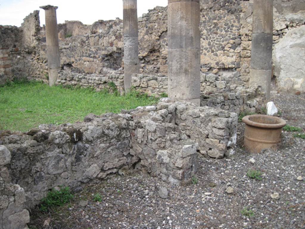 I.3.8b Pompeii. September 2010. Looking towards features near west garden wall of east portico. Photo courtesy of Drew Baker.
See Jashemski, W. F., 1993. The Gardens of Pompeii, Volume II: Appendices. New York: Caratzas. (p.26).
According to Warscher, Non  rimasto niente della testa di Vulcano menzionata dal Mau (Bull. Inst. 1871, p. 171). Ma questo testa non  sola testa di terracotta che  stata trovata sul forno di Pompei: prima di quella hanno scavato il forno nel pistrino IX.1.3/30, nel quale  incastrata una testa  del Vulcano o forse dello spirito del fuoco  anche di terracotta, ma di questultima io non ho trovato nessuna menzione. (vedi, il mio Codex Topographicus di Pompei IX, 1). Anche in questo caso sotto la testa di terracotta si trova un fallo.
See Warscher, T, 1935: Codex Topographicus Pompejanus, Regio I, 3:Rome, DAIR.  
(translation: Nothing remained of the head of Vulcan mentioned by Mau (Bull. Inst. 1871, p.171) But this head was not the only terracotta head that had been found on a Pompeii oven: before this they had excavated the oven in the bakery in IX.1.3/30, in which was embedded a head  of Vulcan or maybe of the spirit of the fire,  also in terracotta, but of this last I have found no mention. (see my Codex Topographicus of Pompeii IX, 1). 
Also in that case, a phallus was found under the terracotta head.)
