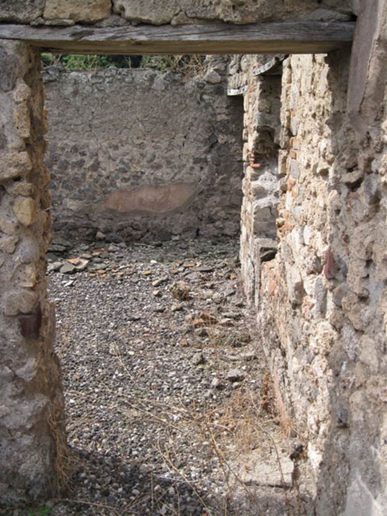 I.3.8b Pompeii. September 2010. Looking west from exedra through doorway at western end of south portico. Photo courtesy of Drew Baker.
