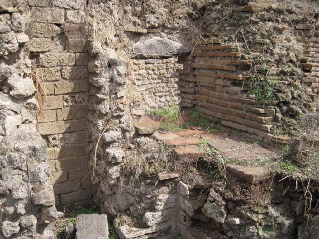 I.3.27 Pompeii. September 2010. Looking towards east wall and south-east corner of small area in front of oven.  The aperture into the room on the east side of the oven can be seen above the terracotta slabs. Photo courtesy of Drew Baker.
