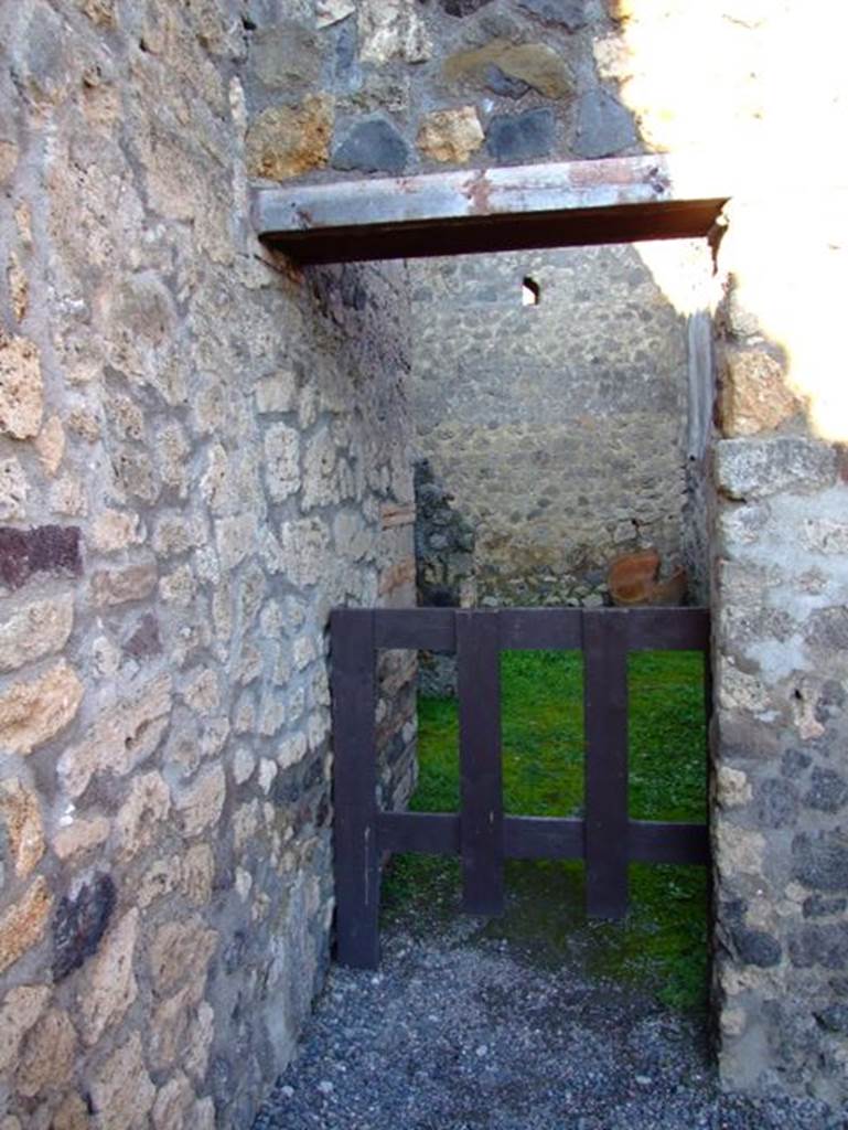 I.4.25 Pompeii. March 2009. Doorway to room 61, looking east, leading to Service Area, rooms 62-63-64.