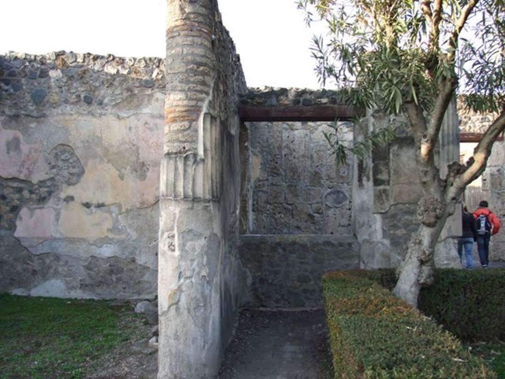 I.4.25 Pompeii. December 2007. 
Looking north in north-west corner of upper peristyle 56, with window from ambulatory on east side of doorway from room 52, in centre.
