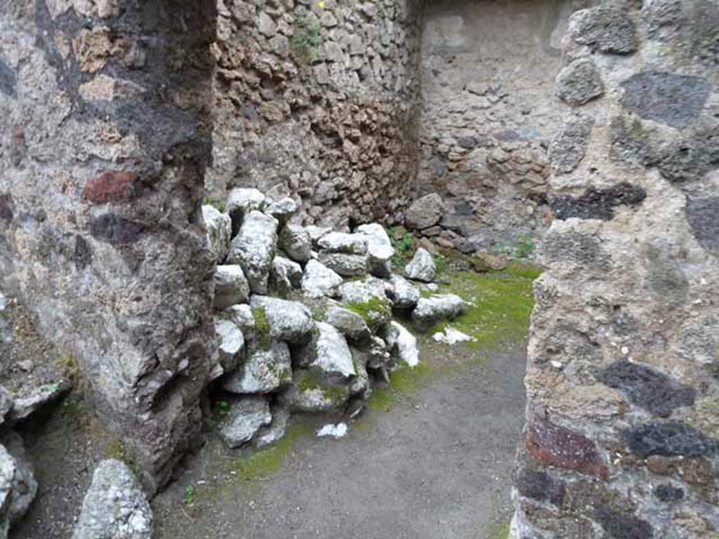 I.6.4 Pompeii. May 2010. Room 10, looking east, with another pile of ancient building material.