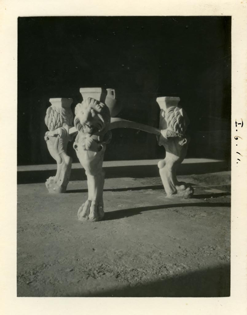 I.6.11 Pompeii. Pre-1937-39. Marble tripod table legs with lion heads and paws, in atrium.
Photo courtesy of American Academy in Rome, Photographic Archive. Warsher collection no. 1851.
