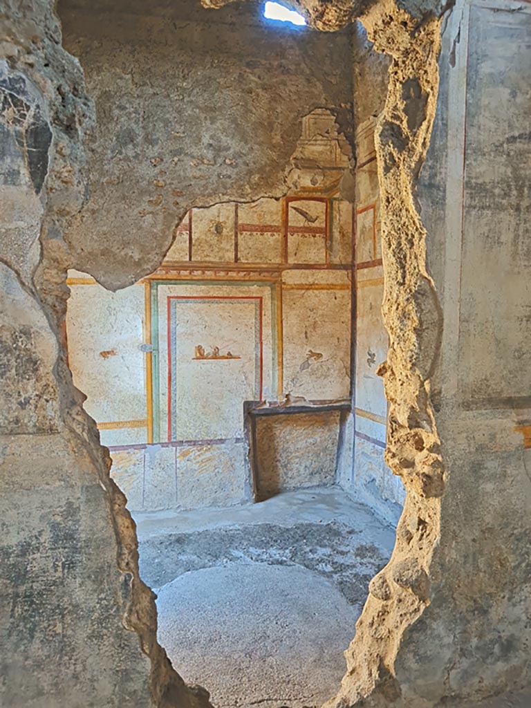 I.7.11 Pompeii. March 2024. 
Looking through hole in north wall of triclinium into cubiculum. Photo courtesy of Giuseppe Ciaramella.
