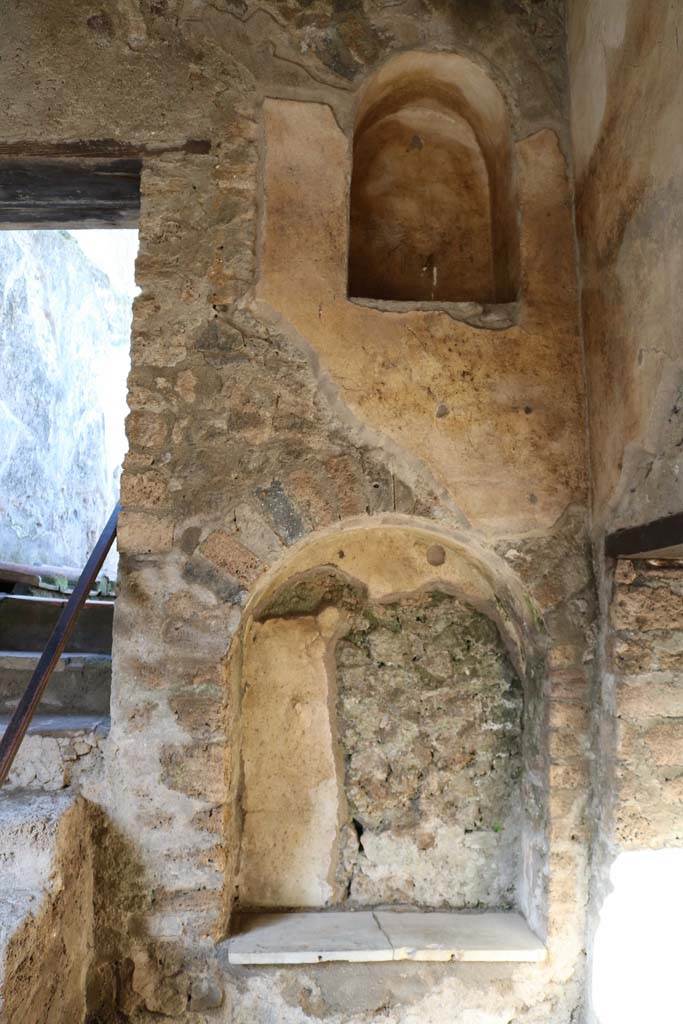 I.7.19 Pompeii. December 2018. 
North wall in north-east corner with two niches. Photo courtesy of Aude Durand.
According to Boyce, in the north wall are two arched niches at different levels.
The lower is the larger and has a slab of marble as its floor.
See Boyce G. K., 1937. Corpus of the Lararia of Pompeii. Rome: MAAR 14. (p.26, no.42). 

