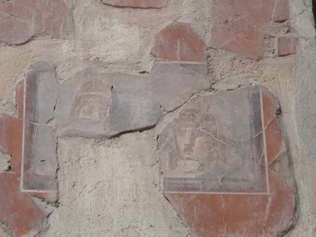 I.10.4 Pompeii. May 2010. West wall of atrium, detail of painted theatrical masks.