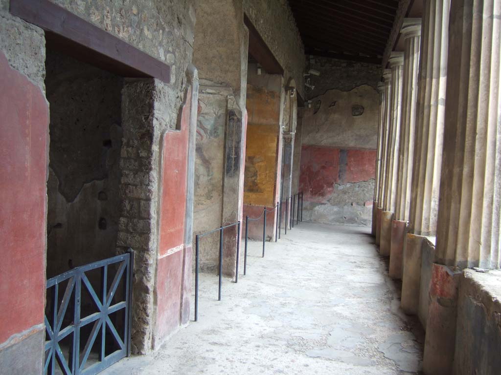 I.10.4 Pompeii. May 2006. South portico. Looking west along doorways of room 21, and alcoves 22, 23, 24 and 25.