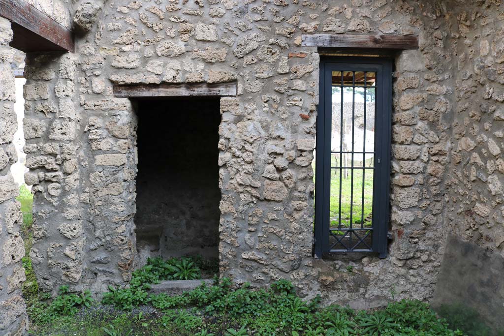 I.11.11 Pompeii. December 2018. Looking east from linking room between I.11.10/11/12, through doorway leading to garden. 
On the left is another latrine, at the rear of the garden latrine in I.11.10. Photo courtesy of Aude Durand.
