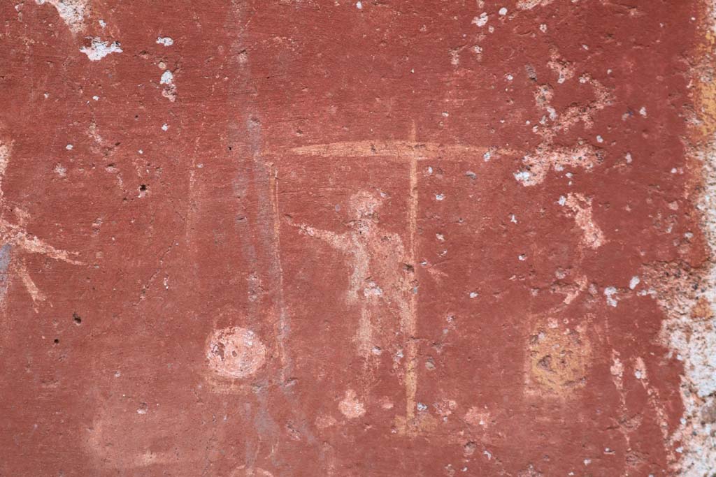 I.14.7 Pompeii. December 2018. Detail from base of lararium. 
Two men in short robes weighing two baskets on large weighing scales. Photo courtesy of Aude Durand.


