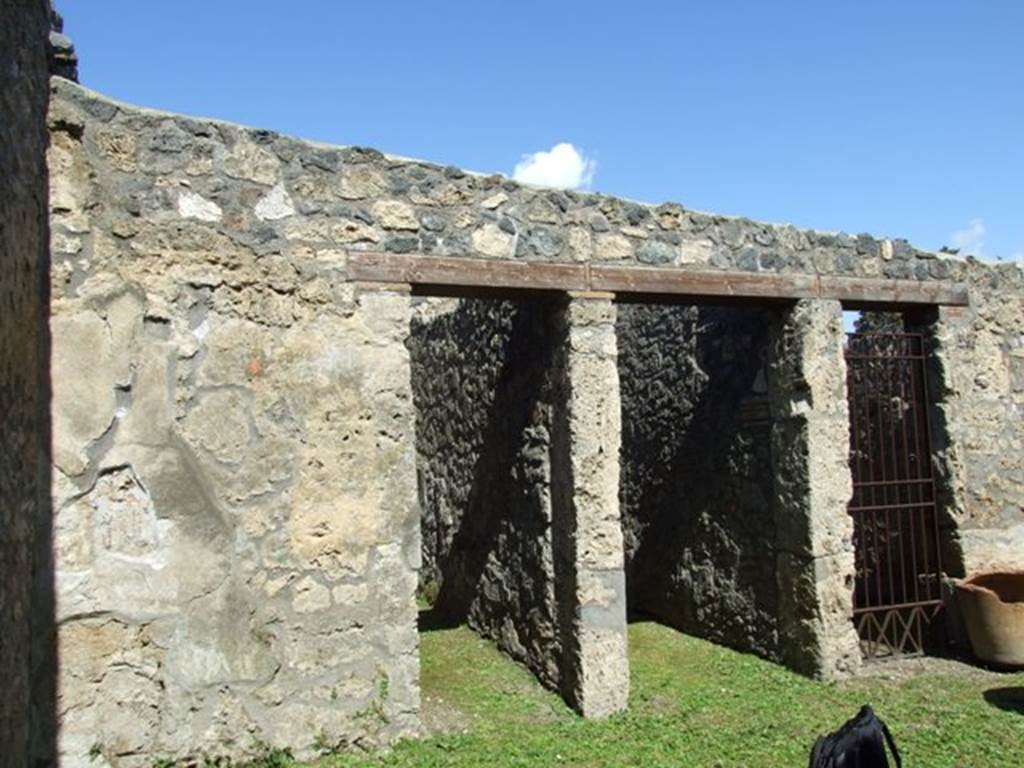 I.14.7 Pompeii. March 2009.  North wall of atrium, with doorway to cubiculum on left (west) side of doorway to entrance fauces, and doorway to shop at I.14.6.
