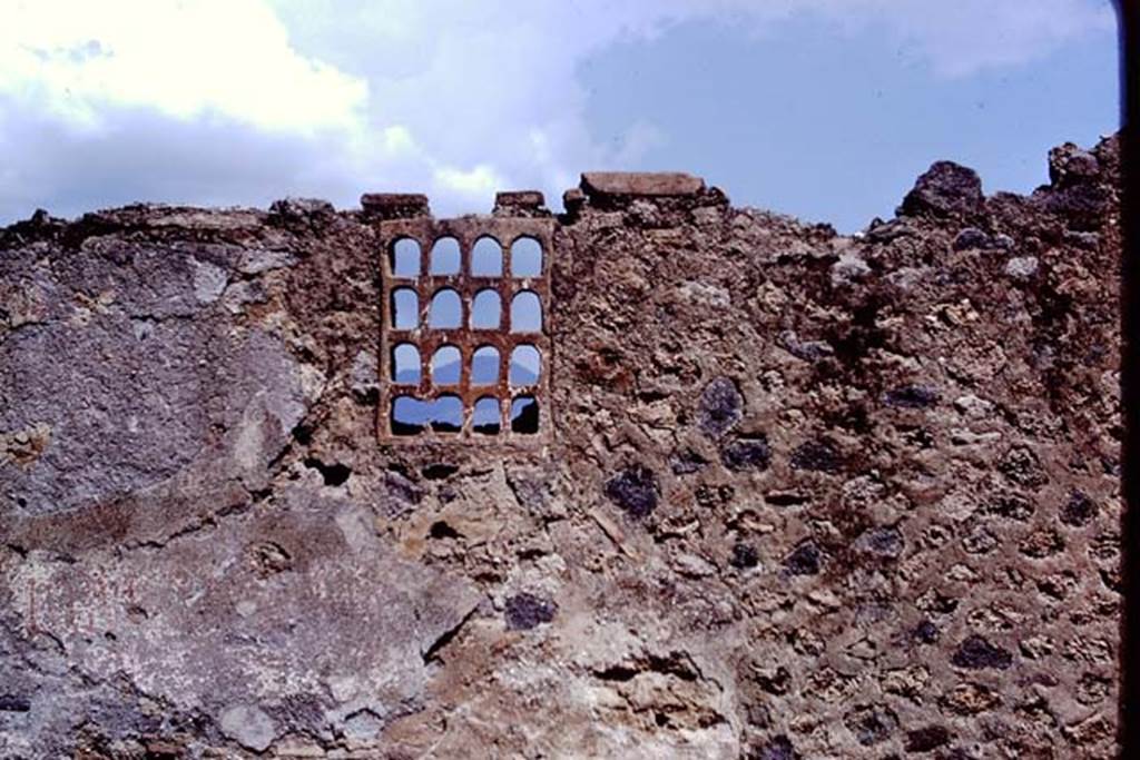 I.14.11 Pompeii. 1972. Terracotta window on east side of entrance doorway, in front exterior wall.  Photo by Stanley A. Jashemski. 
Source: The Wilhelmina and Stanley A. Jashemski archive in the University of Maryland Library, Special Collections (See collection page) and made available under the Creative Commons Attribution-Non Commercial License v.4. See Licence and use details. J72f0219
