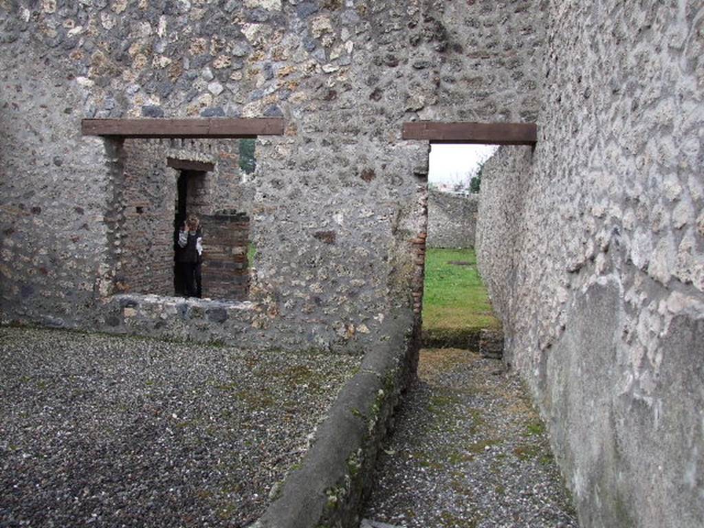 I.16.4 Pompeii. December 2006. Looking south across tablinum (on left) with window to garden, and corridor.