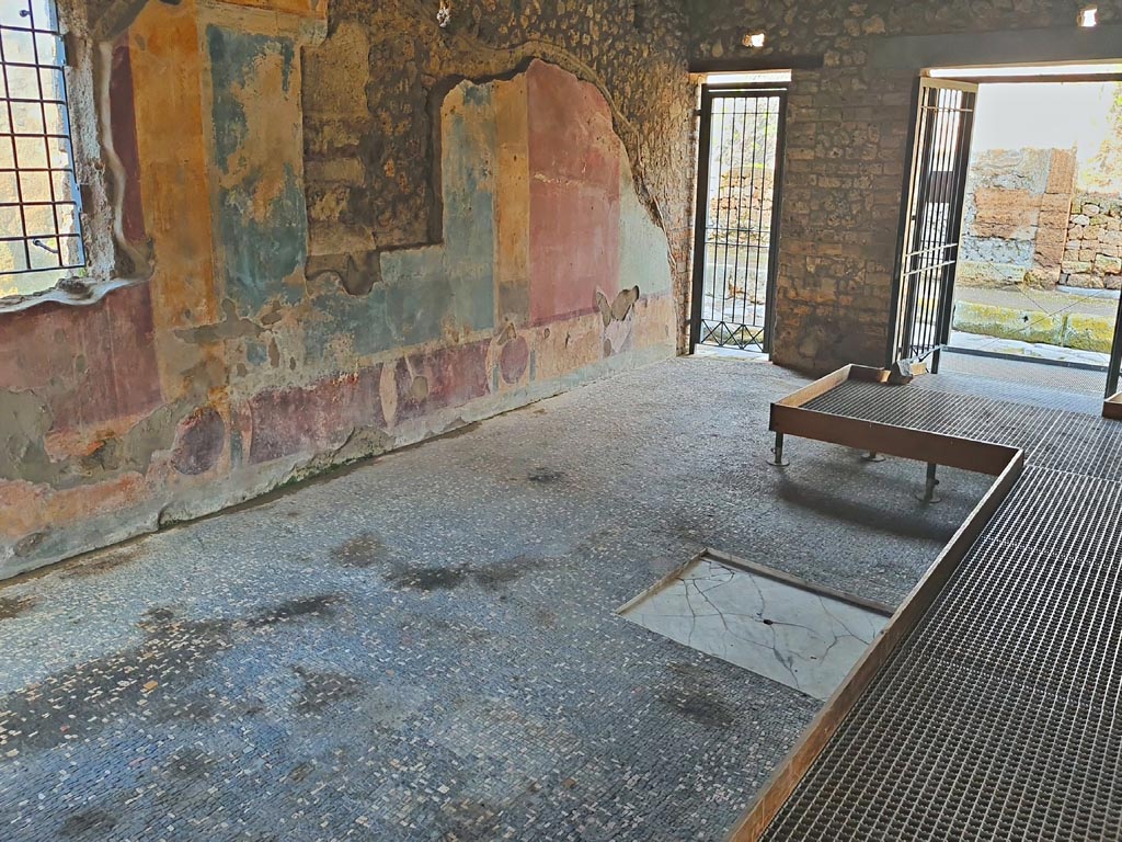 II.4.3 Pompeii. March 2024. 
Looking towards north-west corner  of atrium, and doorway at II.4.2, on left, and II.4.3, on right. Photo courtesy of Giuseppe Ciaramella.
