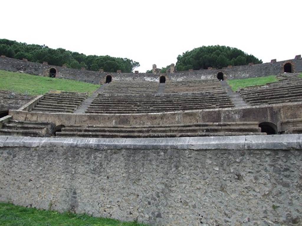 II.6 Pompeii. December 2006. Seating of Amphitheatre, looking north-east. 
Inscribed on the capping stone of the rim of the arena wall is 
MAG. PAG. AVG. F. S. PRO. LVD. EX. D. D.

According to Epigraphik-Datenbank Clauss/Slaby (See www.manfredclauss.de) this expands to
Mag(istri) pag(i) Aug(usti) f(elicia) s(uburbani) pro lud(is) ex d(ecreto) d(ecurionum)       [CIL X, 853]

According to Cooley, this translates as
The presidents of the Fortunate Augustan Suburban Country District (built this) instead of games, by decree of the town councillors.
See Cooley, A. and M.G.L., 2004. Pompeii: A Sourcebook. London: Routledge, p. 46, D1.
