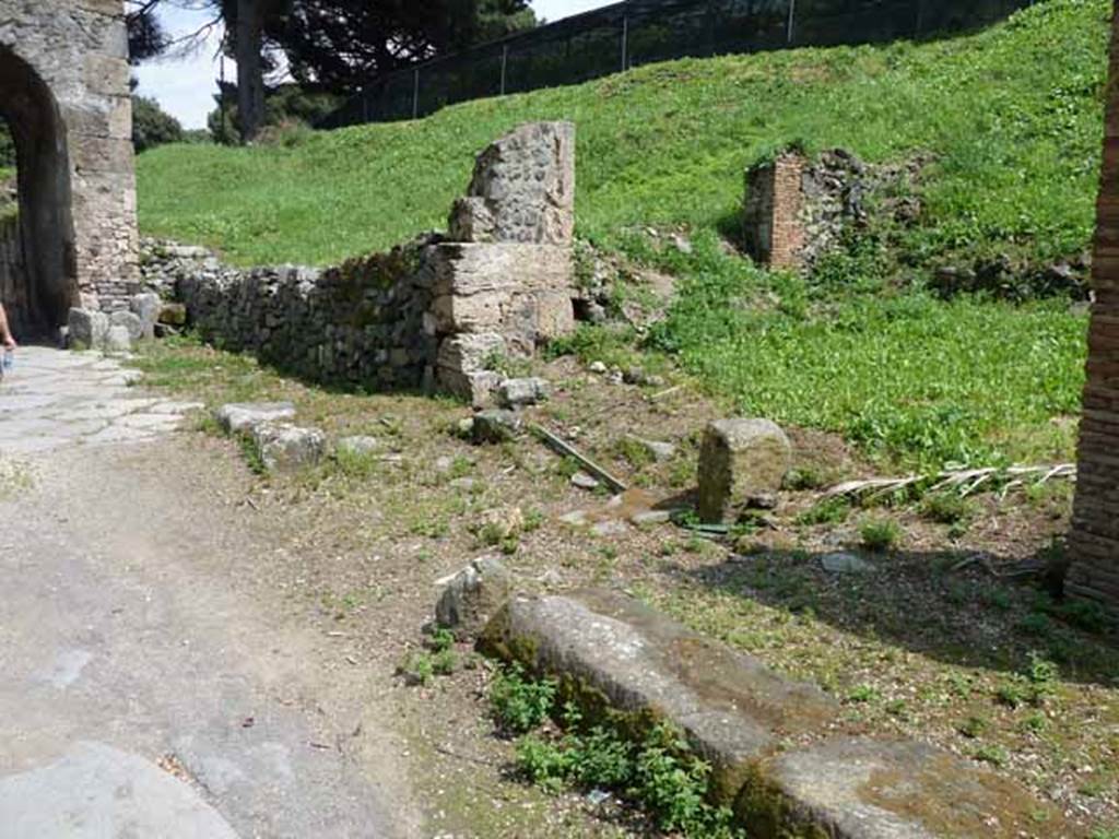 III.11.7 Pompeii. May 2010. Looking east along the south side of Via di Nola. The east side wall with entrance to the blocked unnamed vicolo can be seen. The entrance to the blocked, unexcavated vicolo between III.12 and III.11, would have been behind the modern wall.