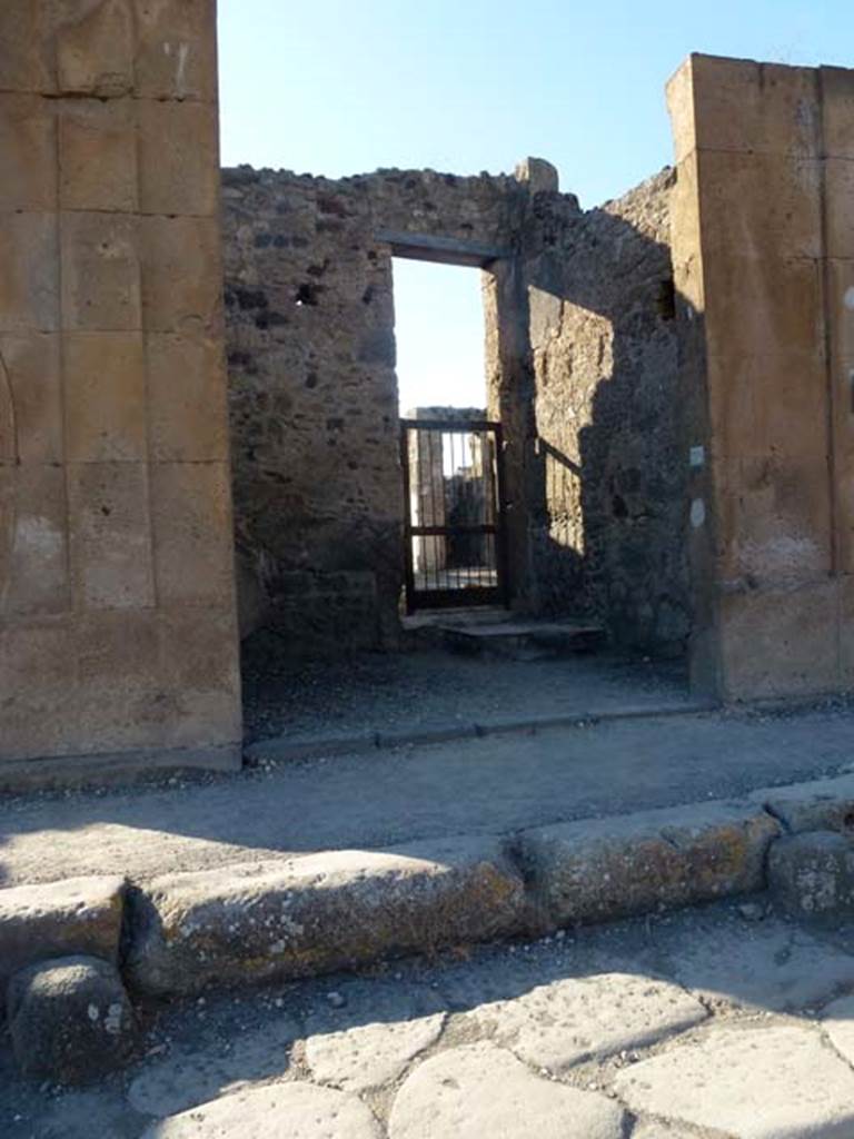 V.1.6 Pompeii. June 2012. Looking north across shop from Via di Nola, towards doorway in north wall to atrium of V.1.7. Photo courtesy of Michael Binns.
