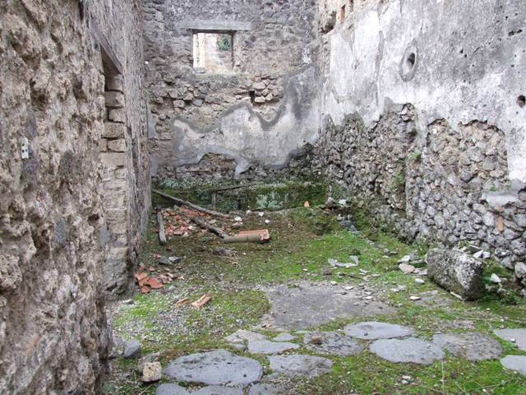 V.4.1 Pompeii. December 2007. Looking west in room “P” to rear of bakery area.
According to NdS,
“A small excavation was carried out on 13th January 1910 in the presence of Lady Aberdeen, Vice-regent of Ireland and her entourage, in the small rustic room at the rear of the house at V.4.1 on the Via di Nola. 
Other than many terracotta items of no value, a bronze bucket of oval shape was found, 0.28m high, with a wide mouth and arched moveable handles of iron, broken and restored by the ancients by means of coarse lead solders (Inv.100).”
See Notizie degli Scavi, 1910, p. 331.
