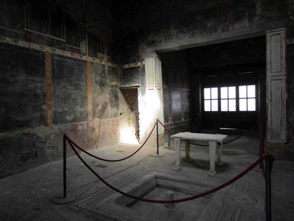 V.4.a Pompeii. March 2012. Looking across impluvium in atrium towards corridor leading to garden area, and north-east corner of tablinum. Photo courtesy of Marina Fuxa.
