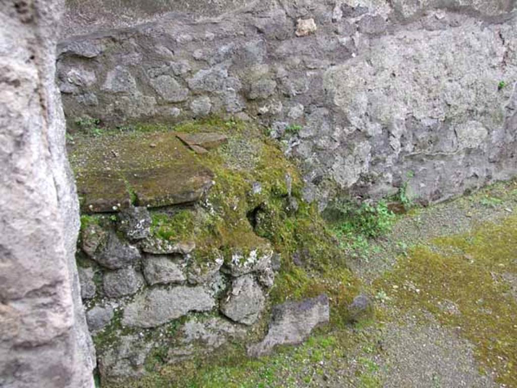 V.5.2 Pompeii. May 2010. Structure in south-west corner of atrium, remains of the hearth in the kitchen area.
