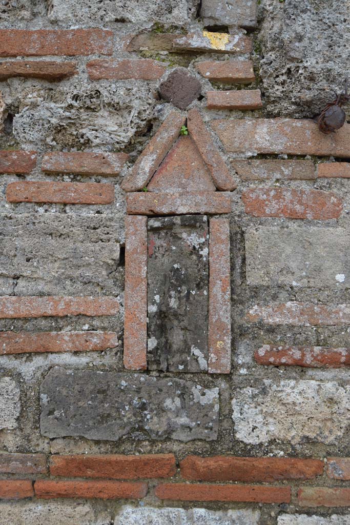 VI.2.25 or VI.2.24 Pompeii. March 2018. 
Terracotta plaque with phallus decoration set into brick pilaster between VI.2.25 and VI.2.24.
Foto Taylor Lauritsen, ERC Grant 681269 DÉCOR.
