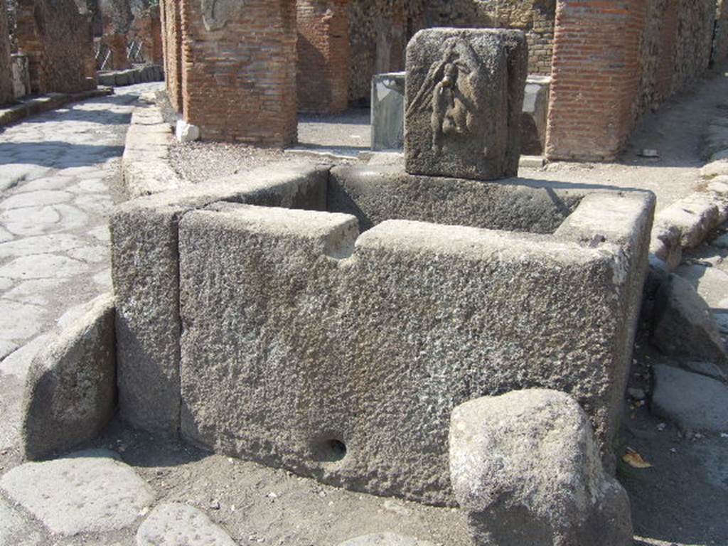 VI.3.20 Pompeii. September 2005. Fountain outside VI.3.20, with bas-relief showing an eagle with a hare in its talons. According to Mau, found on a wall at the south end of insula 3, was a public advertisement of a building to rent. It has now faded and vanished but may have been on a wall between VI.3.20 and VI.3.21. According to Epigraphik-Datenbank Clauss/Slaby (See www.manfredclauss.de), it read as -
Insula Arriana 
Polliana Gn(aei!) Al<le=IF>i Nigidi Mai 
locantur ex <K=I>(alendis) Iuli(i)s primis tanernae 
cum pergulis suis et c{o}enacula 
equestria et domus conductor(is) 
convenito Primum Gn(aei) Al<le=IF>i 
Nigidi Mai ser(vum)      [CIL IV 138]
Mau’s translation read as –
“To rent from the first day of next July, shops with the floors over them, fine upper chambers, and a house in the Arrius Pollio block owned by Gnaeus Alleius Nigidius Maius.  Prospective lessees may apply to Primus, slave of Gnaeus Alleius Nigidius Maius”.
Mau also wrote that the insula named after Arrius Pollio was thought by Fiorelli to be the so-called House of Pansa, across the street from the block on which the advertisement was found. 
The identification may be correct – but a notice painted in so prominent a place might refer to a block in any part of the city.
See Mau, A., 1907, translated by Kelsey, F. W., Pompeii: Its Life and Art. New York: Macmillan. (p. 489).
According to Della Corte, CIL IV 138, was found above one of the external pilasters in the south-west corner of insula VI.6, and not here.
See Della Corte, M., 1965.  Case ed Abitanti di Pompei. Napoli: Fausto Fiorentino. (p.113)
Fiorelli would appear to agree with Della Corte, as he said the advertisement was found on the walls of VI.6.18/19.
This would be on the opposite side of the Vicolo di Modesto from here.
See Pappalardo, U., 2001. La Descrizione di Pompei per Giuseppe Fiorelli (1875). Napoli: Massa Editore. (p.56)


