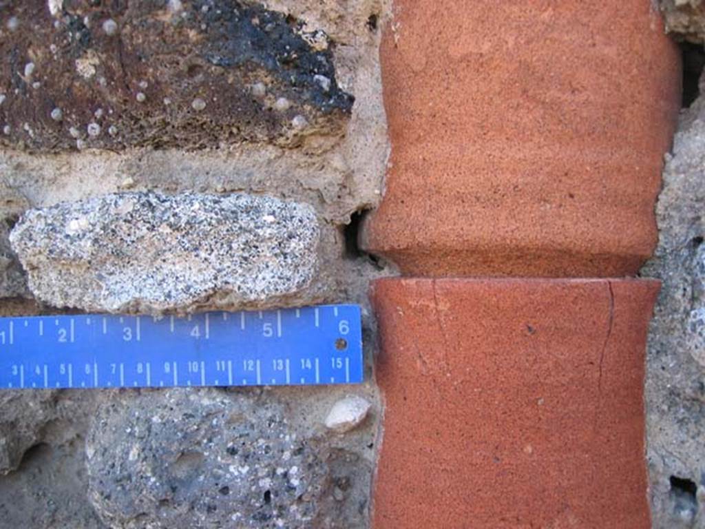 VI.9.14 Pompeii. July 2008. Detail of downpipe in west wall. Photo courtesy of Barry Hobson.