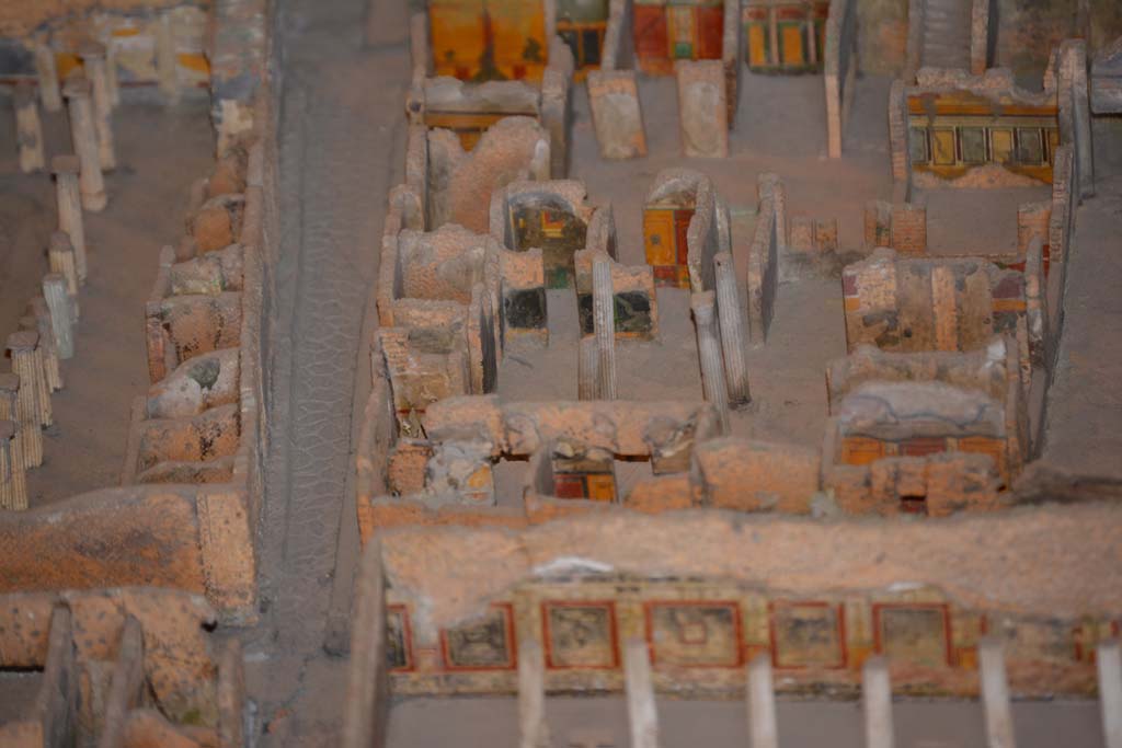 VI.11.9/10 Pompeii. July 2017. Top right, below the stairs, looking towards west wall of room 38, with window into room 35.
Beneath the window, the west wall of tablinum 33 can be seen. 
Across the centre, the west side of atrium 27 features the black painted room 28, the yellow/red painted room 29, undecorated corridor 48, and room 31, west ala.
From cork model in Naples Archaeological Museum.
Foto Annette Haug, ERC Grant 681269 DCOR.
