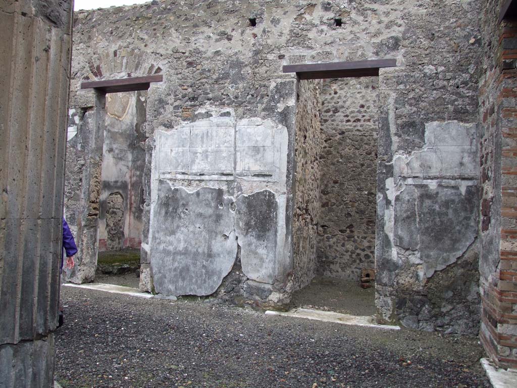 VI.11.10 Pompeii. December 2006. Doorways to rooms 30 and 26 on east side of atrium 27.