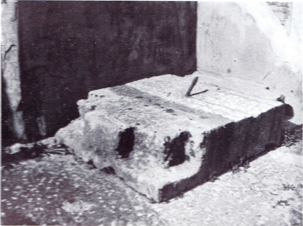 VI.12.2/5 Pompeii. 1932. Second money chest base, seen in north-east corner of atrium. 
According to Pernice –
This was found in the Casa del Fauno, directly north of the impluvium in the north-eastern corner of the four-columned atrium.
Made from a single block of travertine and notched at the corners up to 18 cm deep. 
These notches were filled by the feet of the box, which were bent at right angles. 
This meant that the base and the box standing on it formed an inseparable unit. 
The iron pin that ran from the base through the box provided additional anchoring.
See Pernice, E., 1932. Hellenistische Tische, Zisternenmündungen, Beckenuntersätze, Altäre u. Truhen. Berlin, p. 72, Taf. 43.1.
