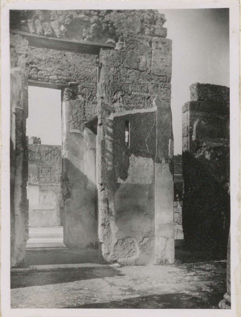 VI.12.5 Pompeii. Pre-1943. West side of tetrastyle atrium 7. (On the right is the west ala 11.) 
Looking west from Tetrastyle atrium towards doorway of room 10 that also served as a passageway between the two atriums.
In this room, there was a rare example of a perfectly preserved interior window with a piece of glass.
(In camera che serviva di passaggio fra i due atri, (attraversa la seconda porta si vede la parete del cubicolo no.17 – sul lato occidentale dell’atrio toscanico) – vi era un raro sempio di una finestra interna perfettamente conservata con un pezzo di vetro.)
See Warscher, T. (1946). Casa del Fauno, Swedish Institute, Rome. (p.58, n.83).

According to Garcia y Garcia, in his description of fig. 162 on p.84, same photo as above -he says –
“Atrio tetrastilo, lato occidentale prima del bombardamento: la finestrella a destra dell’ingresso era dotato da vetro al momento dello scavo.”(Foto T. Warscher).
(“Tetrastyle atrium, west side before the 1943 bombing: the small window on the right of the entrance was equipped with glass at the time of excavation”.)
See Garcia y Garcia, L., 2006. Danni di guerra a Pompei. Rome: L’Erma di Bretschneider. (p.84, fig.162).
