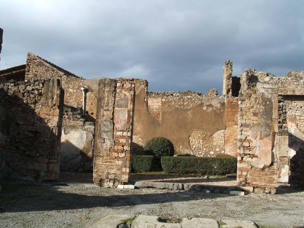 VI.14.12 Pompeii. December 2004. North side of atrium and garden area.
According to Jashemski, the garden at the rear of the house was excavated in 1874, without a tablinum.
There was a portico on the south and east sides, supported by two columns.
The two rooms on the west and east sides of the garden, each had a window overlooking it.
See Jashemski, W. F., 1993. The Gardens of Pompeii, Volume II: Appendices. New York: Caratzas. (p.149)
